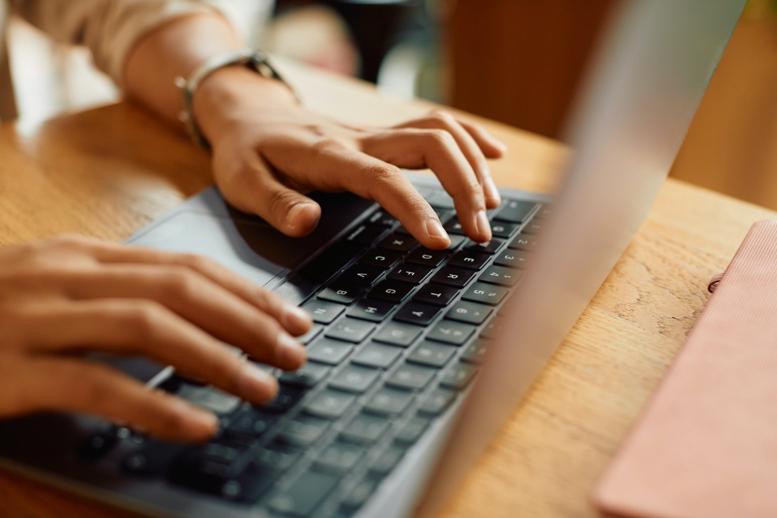 Close-up of businesswoman typing an e-mail on laptop.